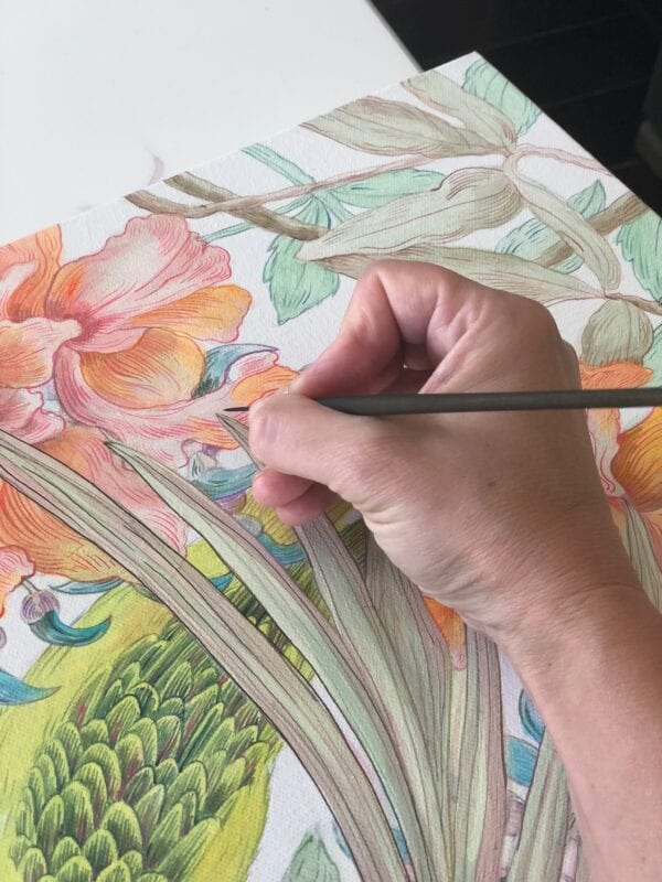 A person is drawing a flower on a piece of paper, inspired by the vibrant colors of "I Heard it Through the Jade Vine" blue naped parrot and the graceful curves of the jade vine.