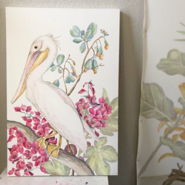 A watercolor painting of a pelican sitting on a branch, available as the "My Mykonos Morning" pelican art print.