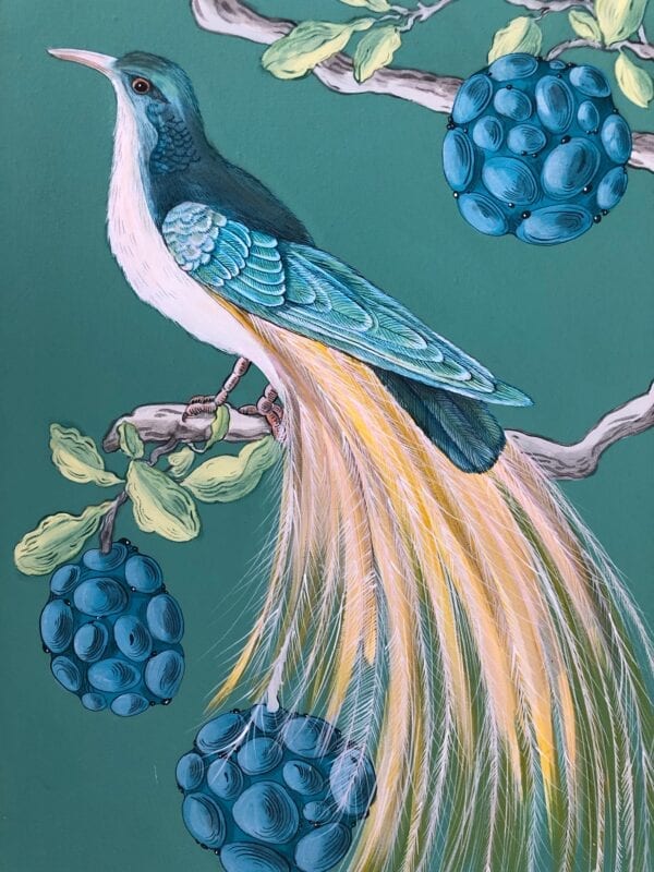 A painting of a bird perched on a branch with blueberries.
