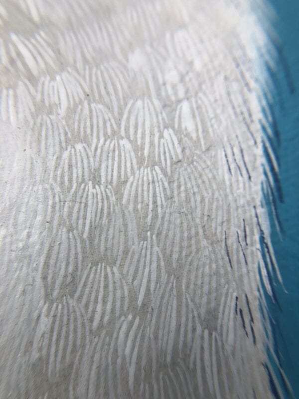 A close up of a white feather on a blue surface, reminiscent of the "Nothing to Egret" coastal bird painting.
