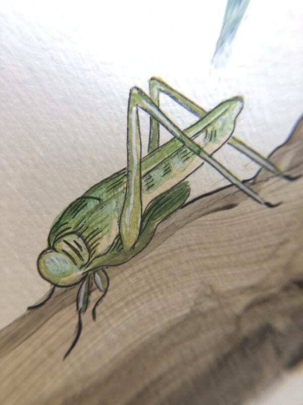 A drawing of a green grasshopper on a piece of wood.