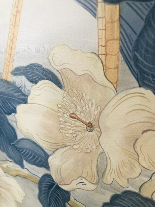 A "The Coast is Clear" blue Chinoiserie coastal print of flowers on a wall.