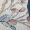 A close up of a painting of flowers and leaves.