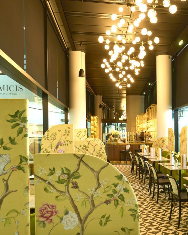 The interior of a restaurant is decorated with the "Scent-sational" Chinoiserie bird with peonies art print.
